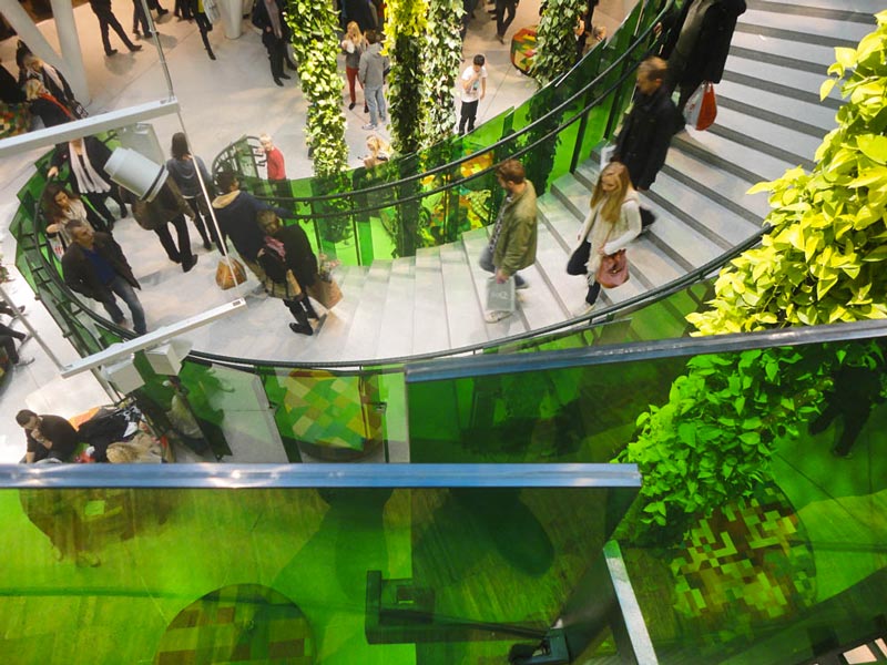 hanging plants and people walking on stairs at Emporia shopping center in Malmo, Sweden