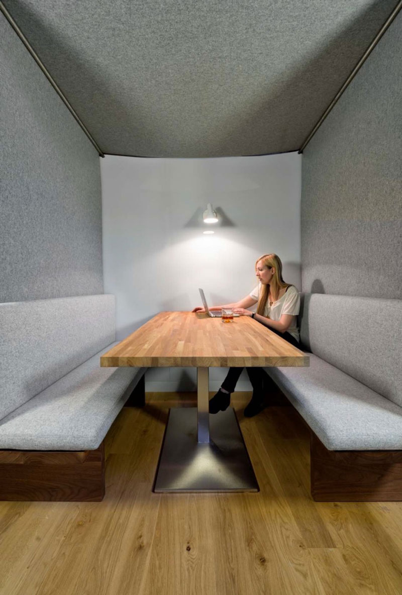 Woman in a booth sitting on a cushioned bench at Giant Pixel headquarter in San Francisco