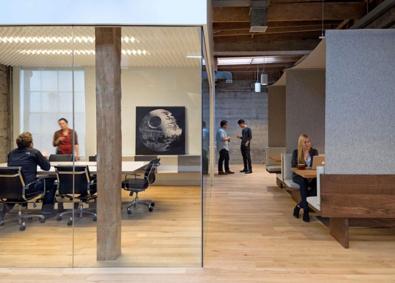 Employees in a conference room at the Giant Pixel headquarters in San Francisco designed by Studio O+A