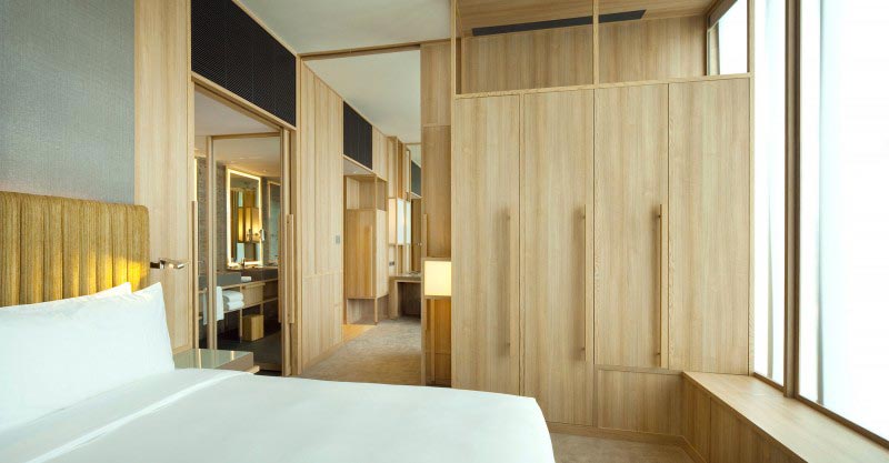 bed and closet at the Parkroyal Singapore