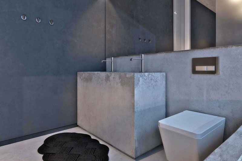 Concrete sink and mirror in the bathroom at the Chair House by Igor Sirotov Jebiga