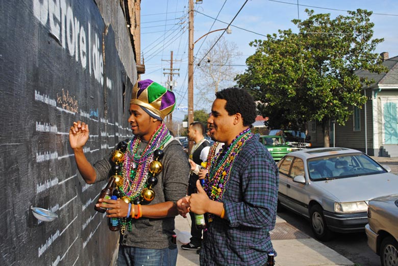 2 men writing on the Before I Die wall by Candy Chang