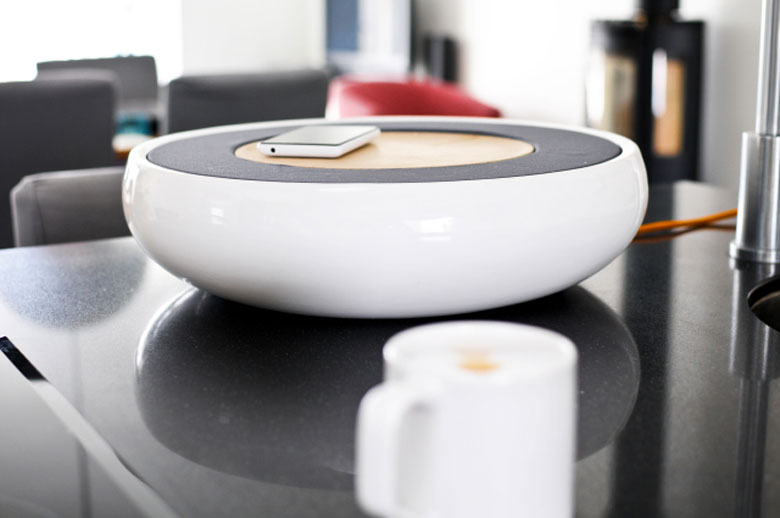 Ceramic Speaker for Smartphones by Victor Johansson on a table top with a smartphone on top of it
