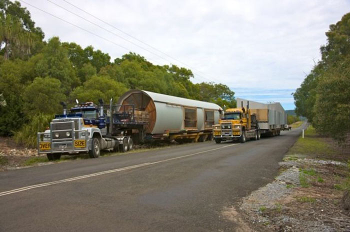 Truck hauling the prefab Drew House by Simon Hills of Anthill Constructions
