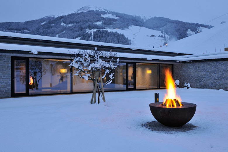 Outdoor fire pit at the Hotel Wiesergut in Hinterglemm Austria by Gogl Architekten