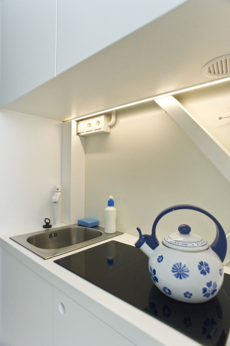 Stove and sink in the kitchen of the Keret House the World's Narrowest Home in Warsaw by Jakub Szczesny