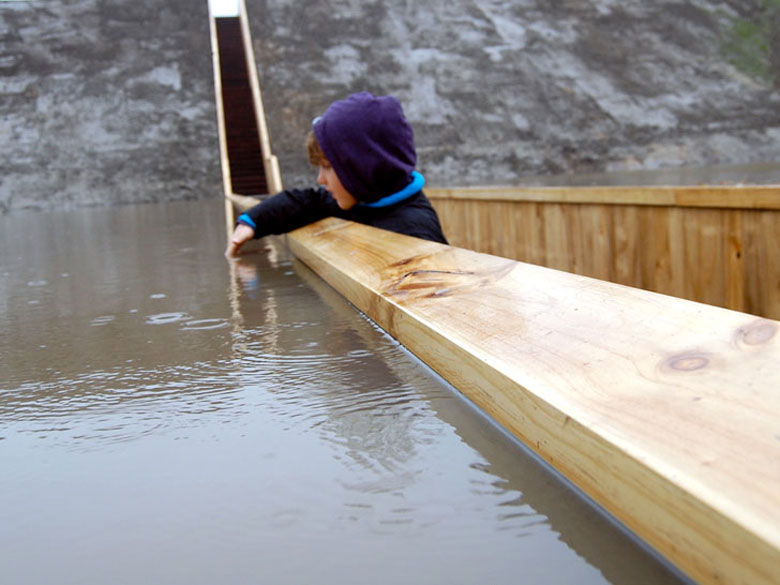 Child reaching out of the Moses Bridge, Sunken Bridge in The Netherlands
