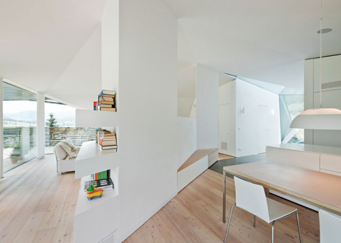 White walls and wooden floors of the interior of the Paramount Alma Residence by Plasma Studio