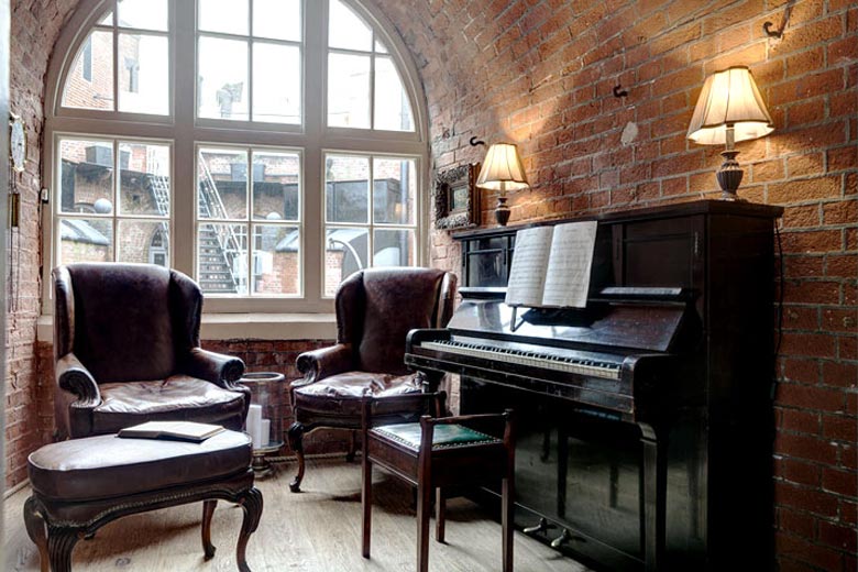Piano next to a large window at the Spitbank Fort Hotel on the coast of Portsmouth England