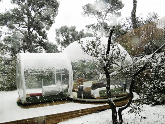 Attrap Reves Bubble Hotel Made of Transparent Tents during winter under a layer of snow