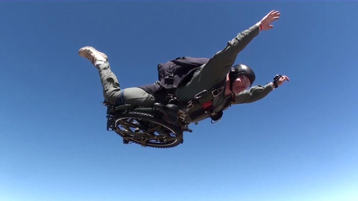 Paratrooper Folding Bicycle by Montague attached to a skydiver