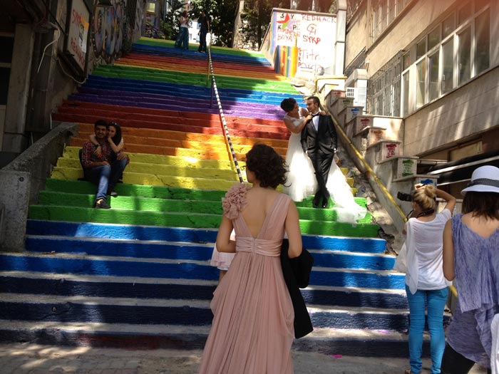 Couple taking wedding photos on the Rainbow Stairs in Istanbul by Huseyin Cetinel