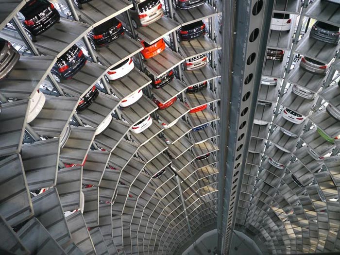 Cars parked inside the Architecture at night of the Volkswagen Car Park at AutoStadt by HENN Architekten