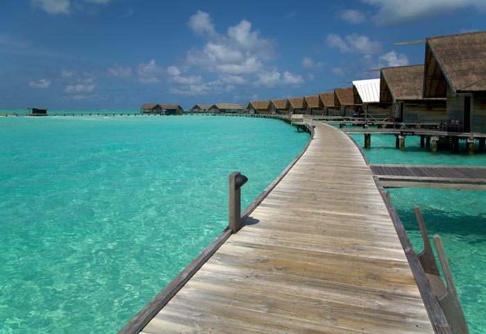 Wooden path over the water at Cocoa Island Resort in The Maldives