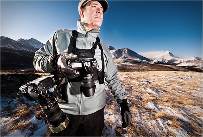 Man using the Cotton Carrier Camera Carrying Vest System for outdoor photography