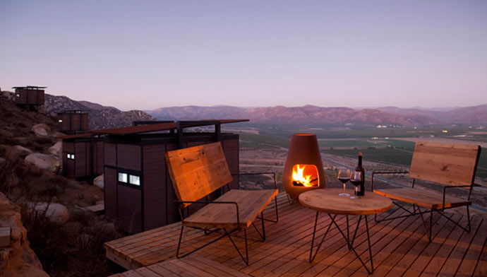 Outside patio with a fireplace and a view of the scenery at ENCUENTRO GUADALUPE ANTIRESORT IN BAJA CALIFORNIA