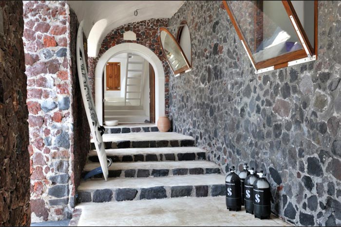 Hallway with stone walls at Perivolas Hideaway in Thirassia, Santorini
