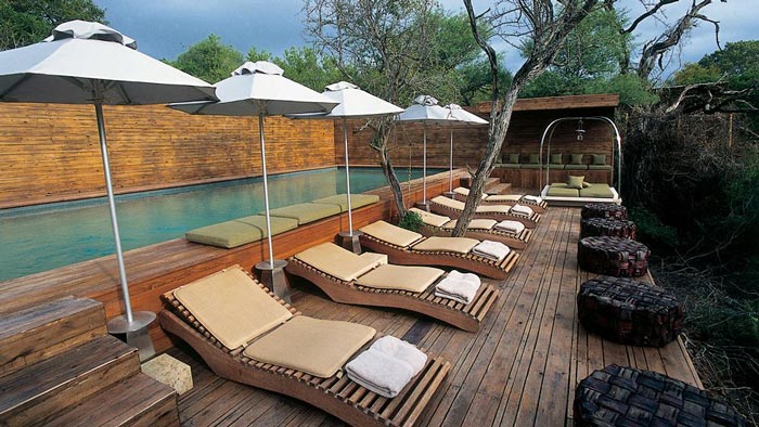 Swimming pool and lounge chairs at Singita Sweni Lodge in South Africa
