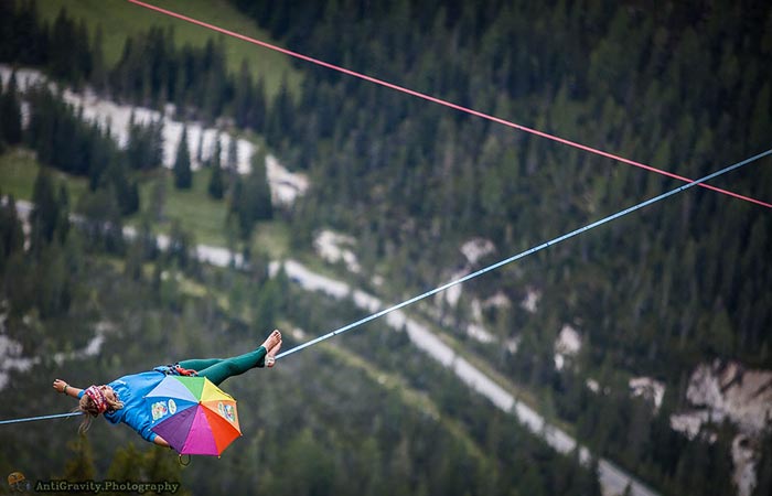 Woman lying down on tight rope at the Slackline Festival