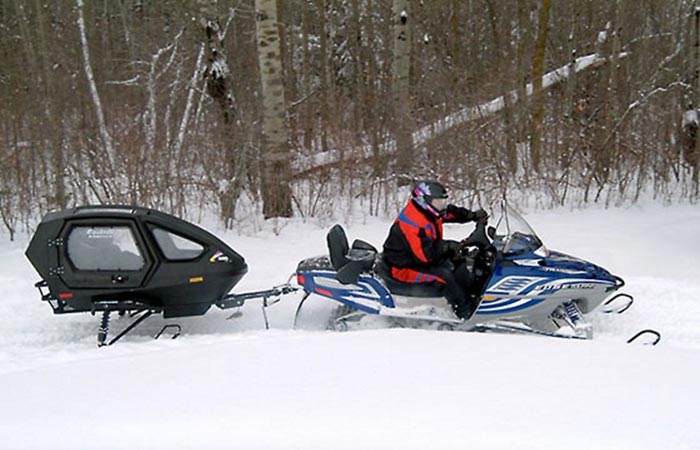 Equinox 685 Snowcoach pulled by a snowmobile