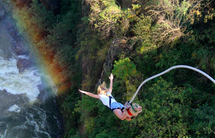 Woman bungee jumping off Victoria Falls