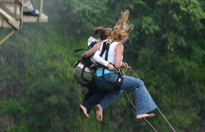 A pair of people bungee jumping together off Victoria Falls