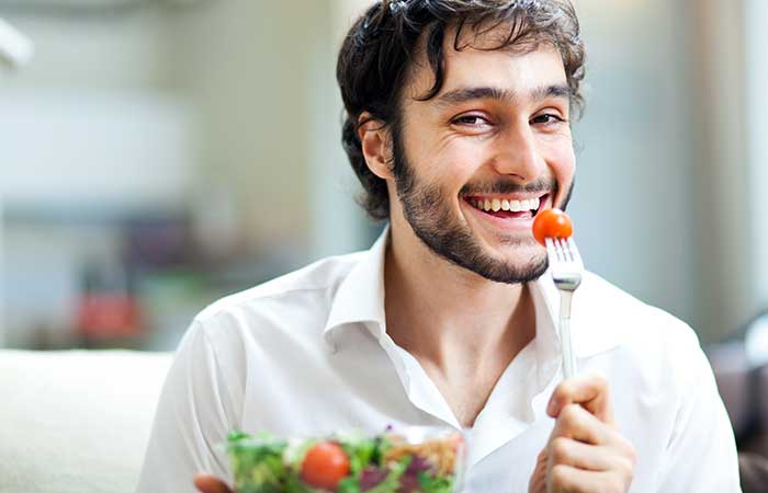 Happy man eating vegan food