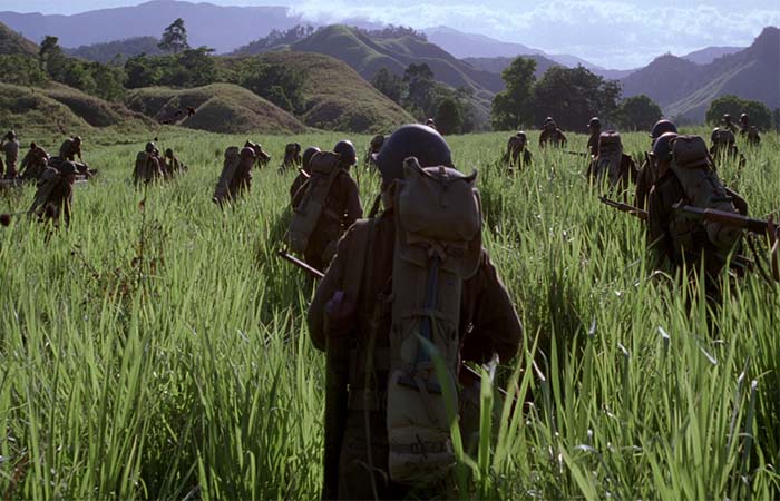 Soldiers walking on the field of grass in The Thin Red Line