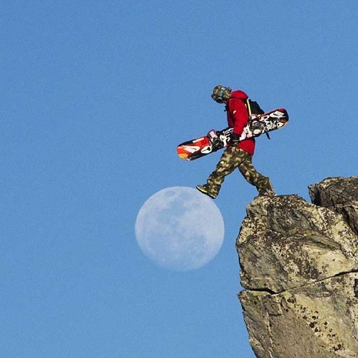 Snowboarder stepping on the Moon.