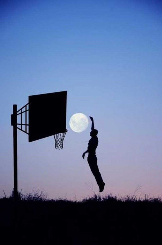 A guy playing basketball with moon