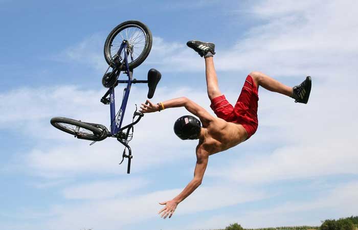 A cyclist falling from his bike in air