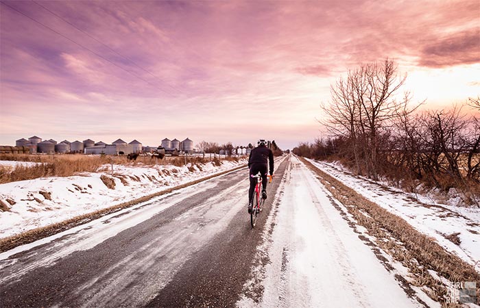 A Guy Riding A Bike In Winter