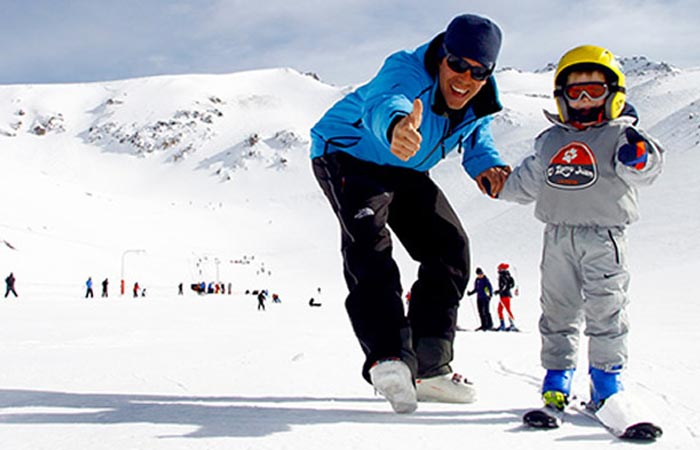 Skiing instructor with a child in La Hoya, Argentina.