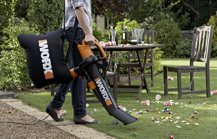 Man cleaning after party with WORX WG509 Electric TriVac BlowerMulcherVacuum