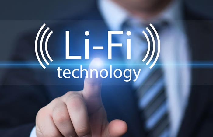 A man pointing a finger with LED light sparkling and a caption saying ''Li-Fi technology''.
