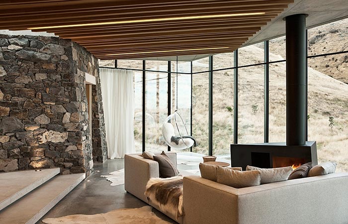 Seascape Retreat on a South Pacific Cove, living room with a sofa and a view at the rocky hills.