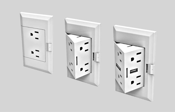 theOUTlet innovation in three electrical boxes on a grey wall, one hidden, and two open devices. 