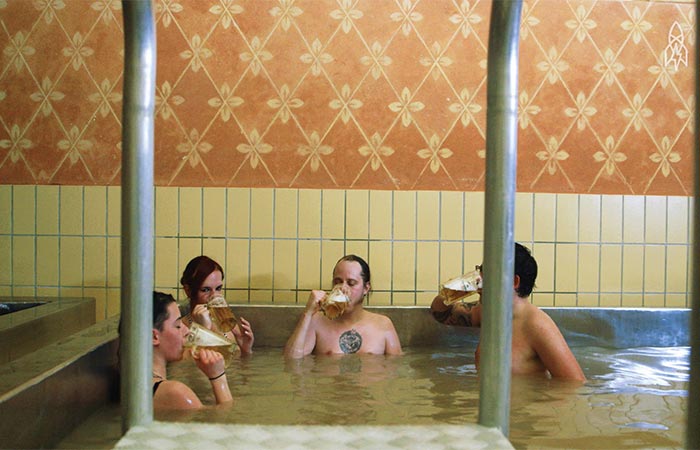 People Sitting In Beer Hot Tub and Drinking Beer