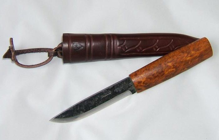 Helle Viking Knife with the protective leather sheath, on a white sheet.