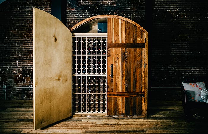 Sommi WIne Cellar in front of a brick wall, semi-open.