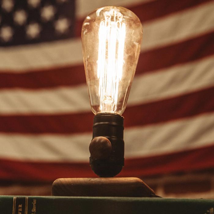The lamp captured with the United States flag behind it. 