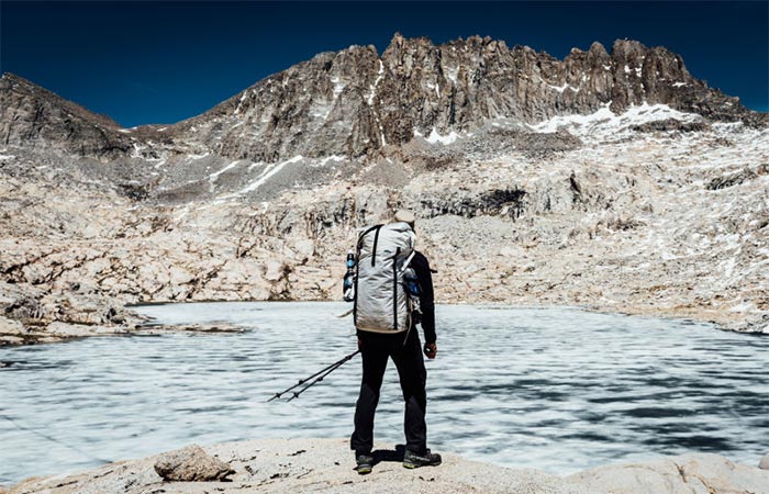 A Guy Wearing 4400 White Porter Pack Next To A Lake 