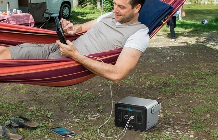 Anker Powerhouse charging a tablet and mobile while camping