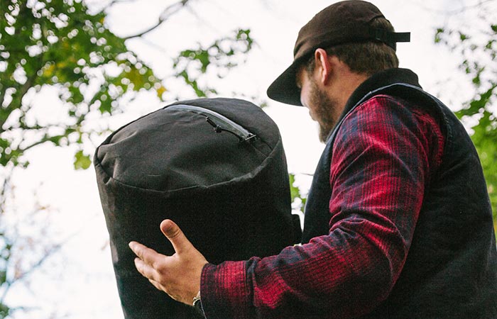 A Guy Carrying Black Stormproof Duffle