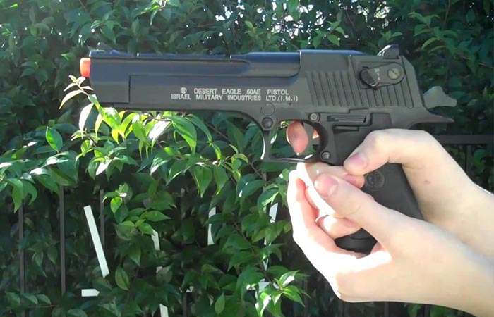 Desert Eagle airsoft pistol being held outside