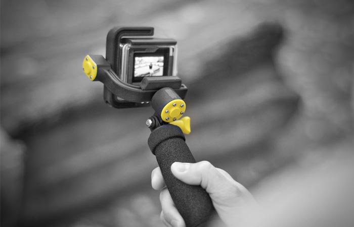 Black And White Image Of A Hand Holding STABYLIZR GoPro Camera Stabilizer