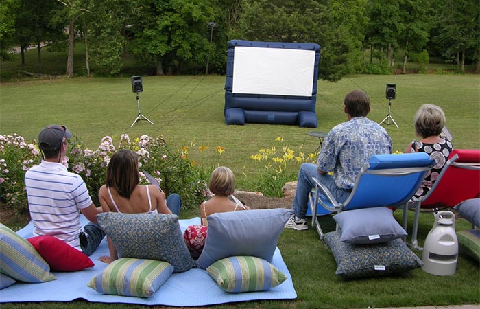 People Outdoors Looking At Gemmy 12 Ft Inflatable Deluxe Movie Screen