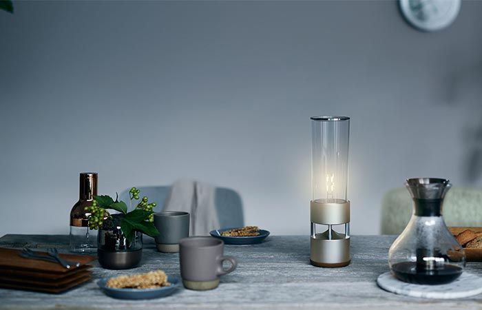 Sony Glass Sound Speaker On A Table With More Things On It
