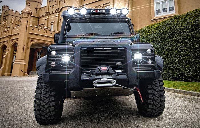 Land Rover Defender 90 Spectre Edition standing outside with lights on