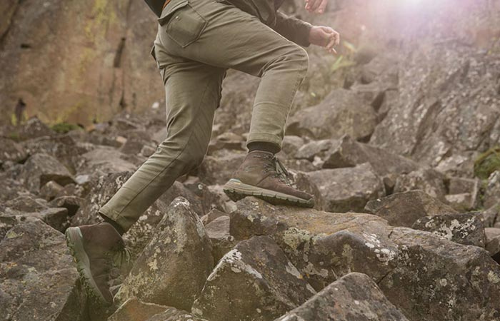 A Guy Climbing Rocks In Danner Mountain 600 Hiking Boots